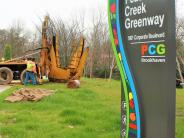 The first of 44 trees is positioned at its new location along Brookhaven’s Peachtree Creek Greenway.