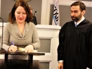 Brookhaven District 1 Council Member Linley Jones signs the oath of office from State Court Judge Mike Jacobs.