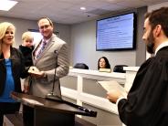 New Brookhaven District 3 Council Member Madeleine Simmons takes the oath of office from Judge Mike Jacobs alongside husband Pet