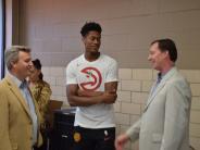 Mayor John Ernst (left) and Council Member Bates Mattison (right) talk basketball with Atlanta Hawks forward De’Andre Hunter