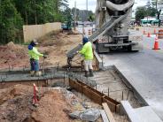 Crews pour a new spillway to improve drainage near the intersection of Ashford Dunwoody Road and Johnson Ferry Road