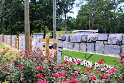 A new decorative fence and granite pillars provide a landscaping facelift for Blackburn Park.