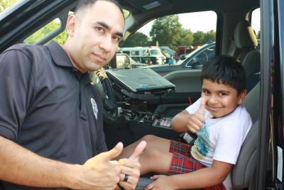 Brookhaven Officer Carlos Nino shares a moment with a young BPD fan at 2018 National Night Out.