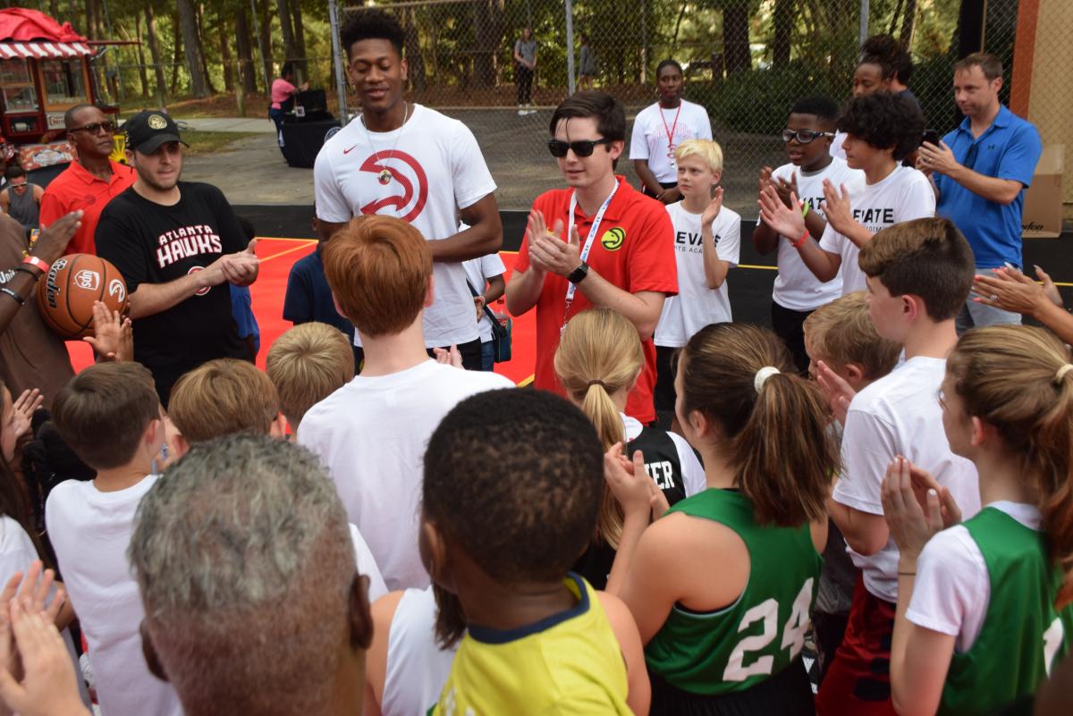 Atlanta Hawks forward De’Andre Hunter meets with kids on the new basketball courts at Lynwood Park.