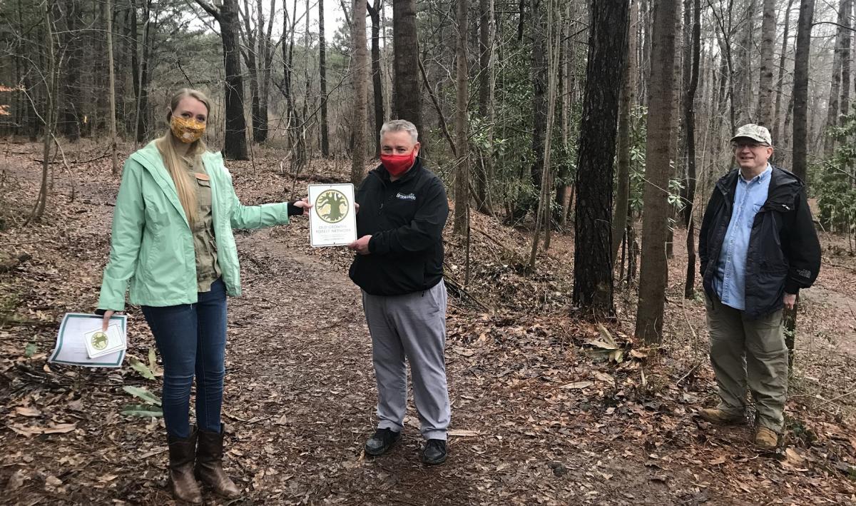 Dr. Sarah Horsley presents the OGFN plaque to Parks Director Brian Borden and Ken Yates, w/the N. DeKalb Greenspace Alliance